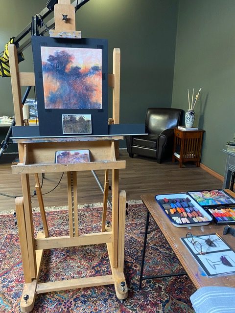 In the recording studio. The demo painting in progress with accompanying reference photo, and pastels.
