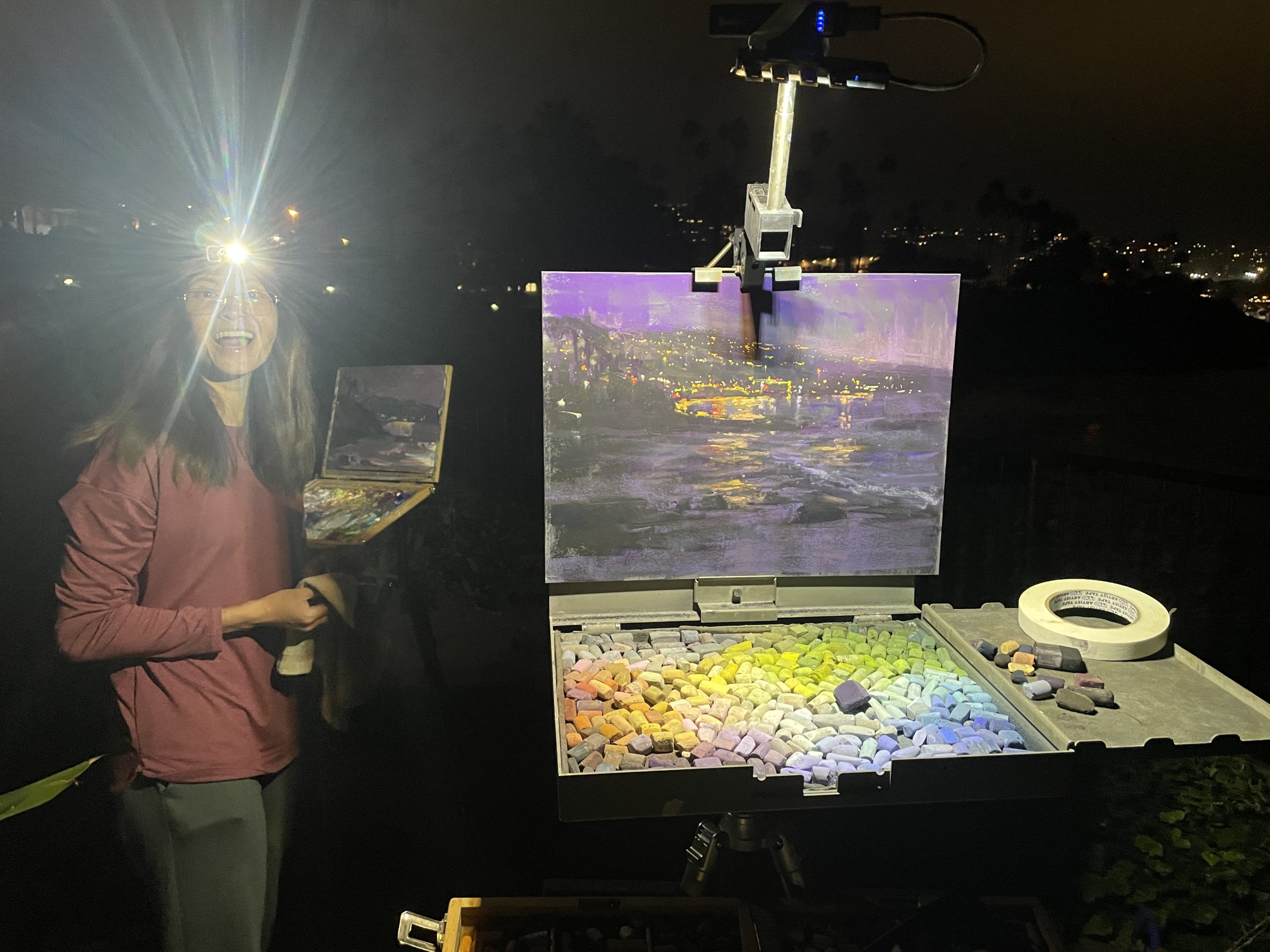 Aaron Schuerr's "Laguna Lights" on the easel. "Tiffanie Mang painting a nocturne with me. Painting with other artists makes me so happy."